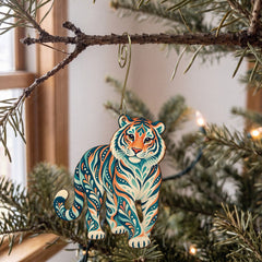 Laser-cut maple wood Amur Tiger folk art ornament O345 hanging on a fir branch, made in USA