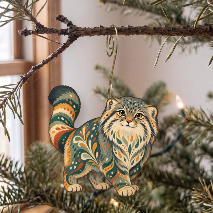 Laser-cut maple wood Pallas's Cat folk art ornament O355 hanging on a fir branch, made in USA
