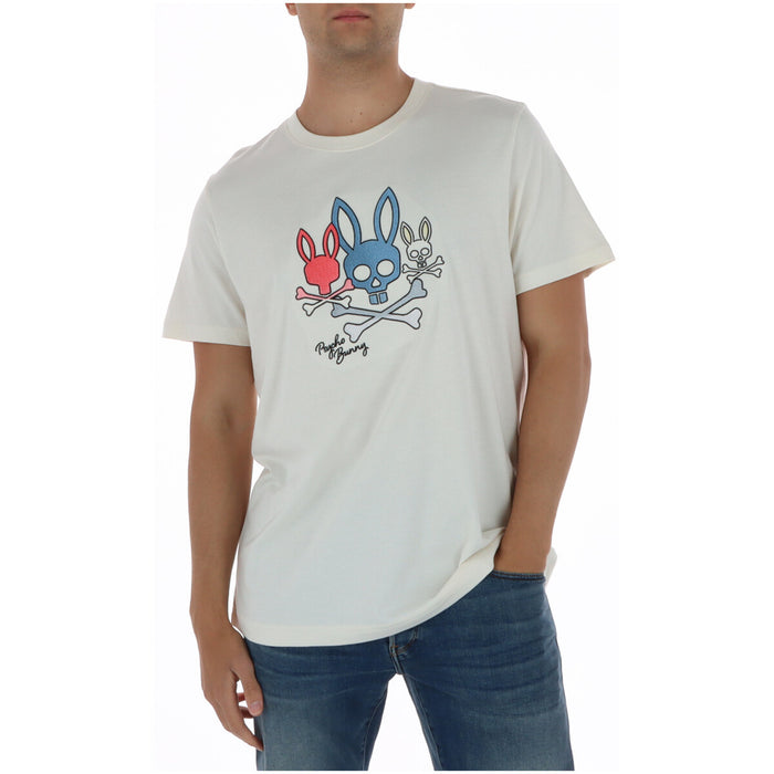 Image 1 : T-shirt homme Psycho Bunny blanc à motif trio skulls et lapins brodés multicolores, porté par un homme en jean bleu — Delvale