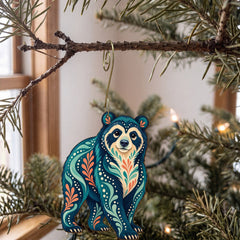 Laser-cut maple wood Andean Bear folk art ornament O369 hanging on a fir branch, made in USA