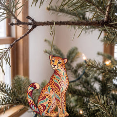 Laser-cut maple wood Cheetah folk art ornament O350 hanging on a fir branch, made in USA