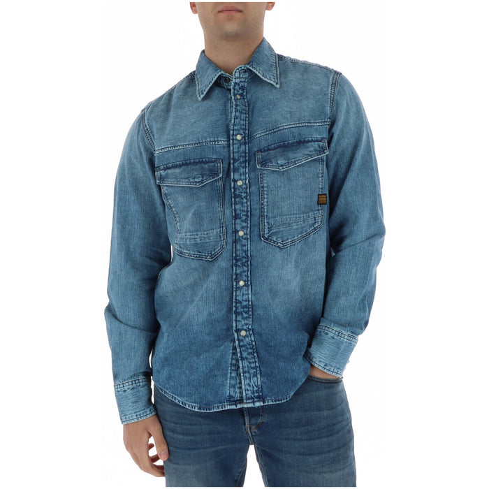 Image 1 : Chemise en jean G-Star RAW homme bleu délavé manches longues double poche poitrine portée avec un jean — Delvale