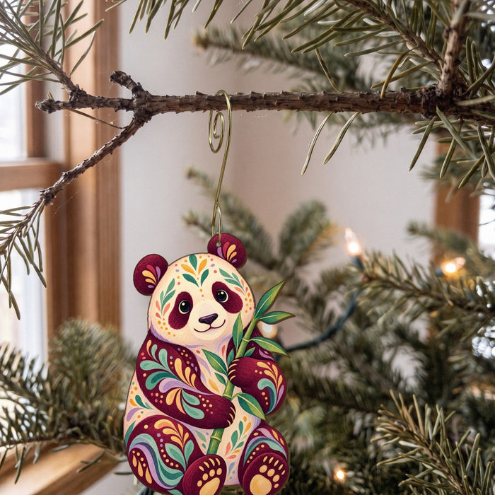 Laser-cut maple wood Giant Panda folk art ornament O366 hanging on a fir branch, made in USA