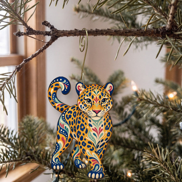 Laser-cut maple wood Jaguar folk art ornament O349 hanging on a fir branch, made in USA
