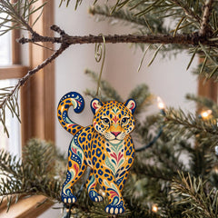 Laser-cut maple wood Jaguar folk art ornament O349 hanging on a fir branch, made in USA