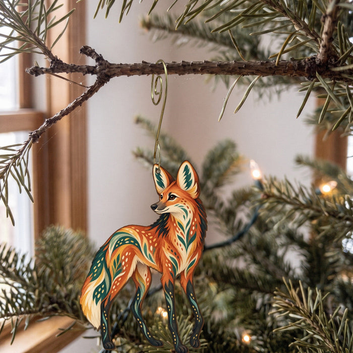 Laser-cut maple wood Maned Wolf folk art ornament O363 hanging on a fir branch, made in USA