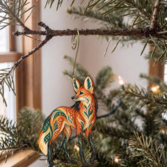 Laser-cut maple wood Maned Wolf folk art ornament O363 hanging on a fir branch, made in USA