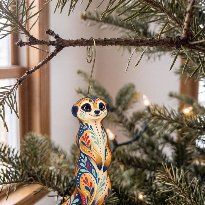 Laser-cut maple wood Meerkat folk art ornament O357 hanging on a fir branch, made in USA