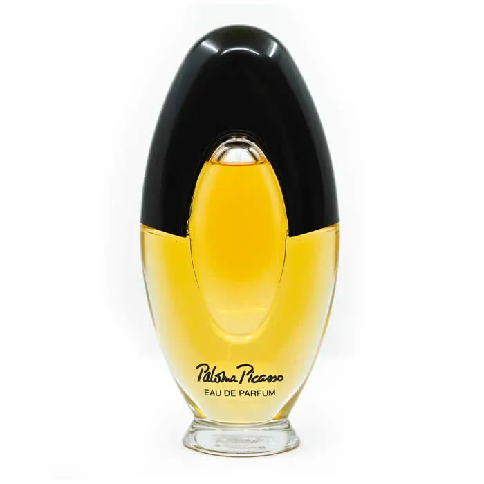 Image 1 : Flacon Paloma Picasso Eau de Parfum vaporisateur 100ml, design bicolore noir et doré avec jus ambré doré visible — Delvale