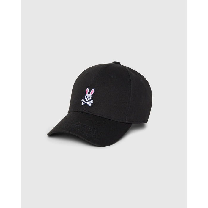 Image 1 : Casquette Psycho Bunny noire de trois quarts avec logo skull bunny brodé en façade sur fond gris clair — Delvale
