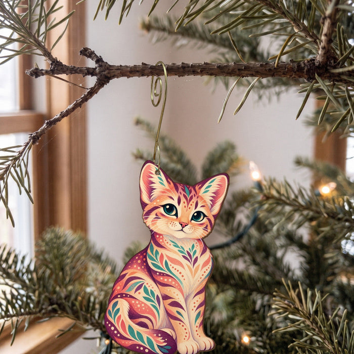 Laser-cut maple wood Sand Cat folk art ornament O356 hanging on a fir branch, made in USA