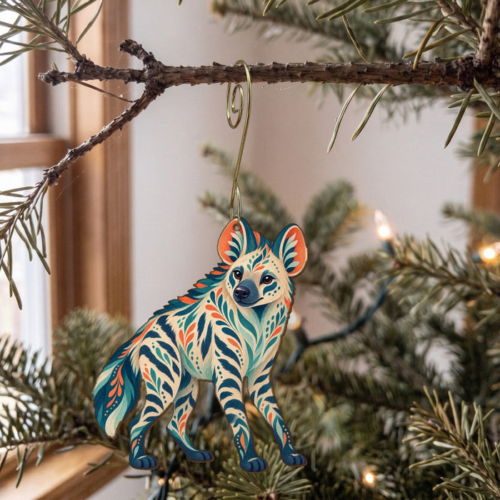 Laser-cut maple wood Striped Hyena folk art ornament O361 hanging on a fir branch, made in USA