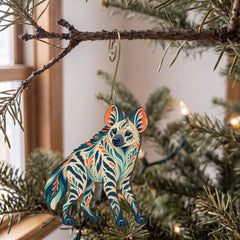 Laser-cut maple wood Striped Hyena folk art ornament O361 hanging on a fir branch, made in USA